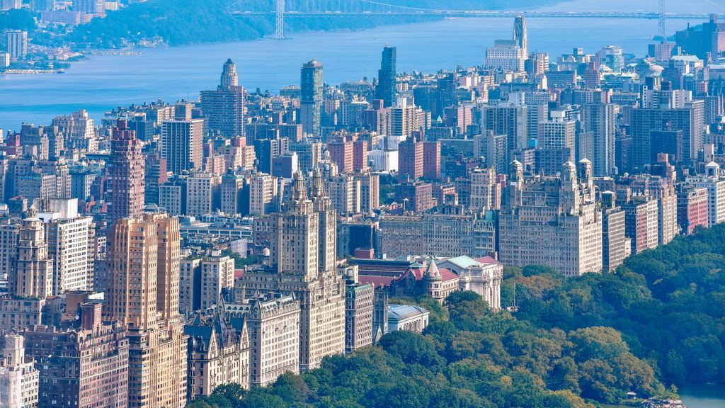 Aerial view of the western edge of Central Park and the Upper West Side, with the Hudson River and the George Washington Bridge beyond