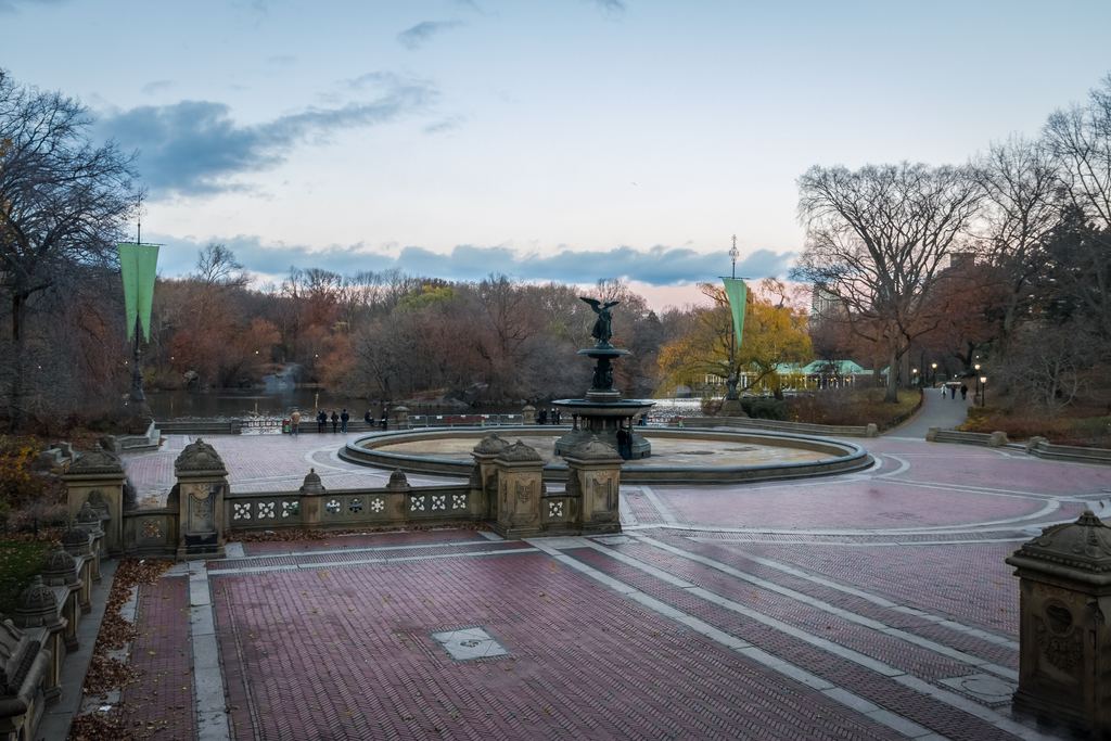 Bethesda Terrace in Central Park with its brick-paved plaza, carved balustrade and the Angel of the Waters fountain, framed by bare late-autumn trees