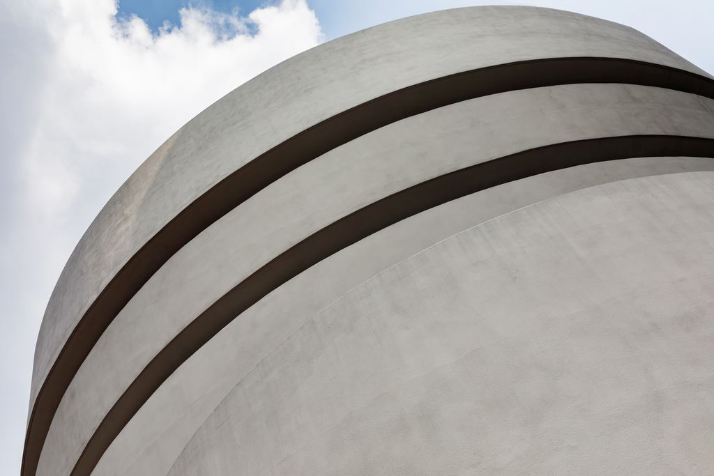 The white curved concrete bands of the Solomon R. Guggenheim Museum on Fifth Avenue, New York, against the sky
