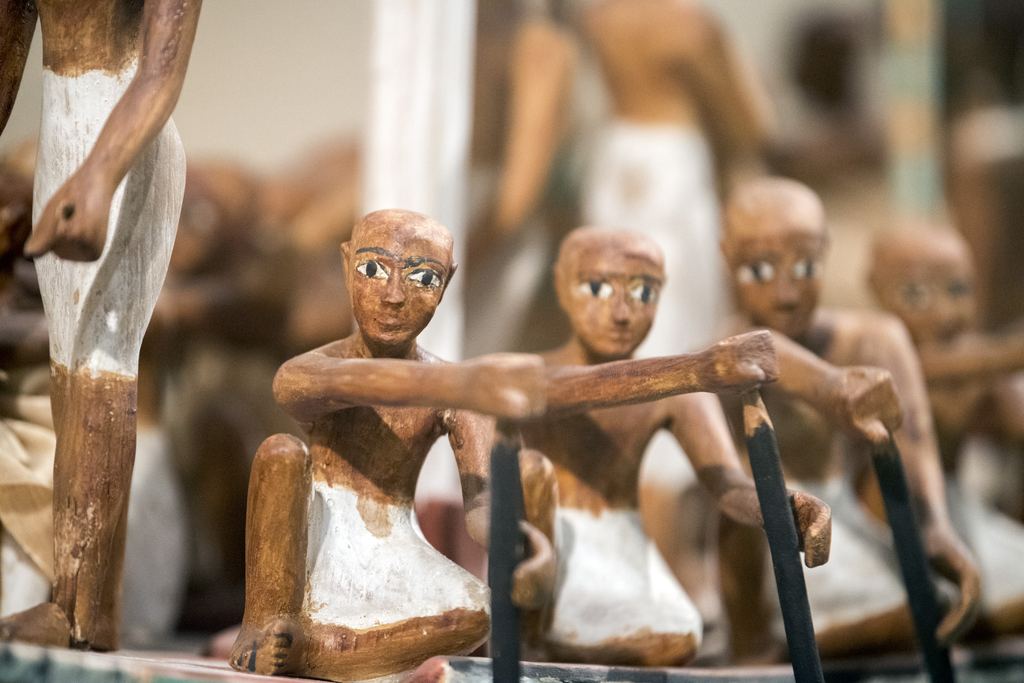 Painted wooden models of seated figures from an ancient Egyptian tomb, in a display case at the Metropolitan Museum, New York