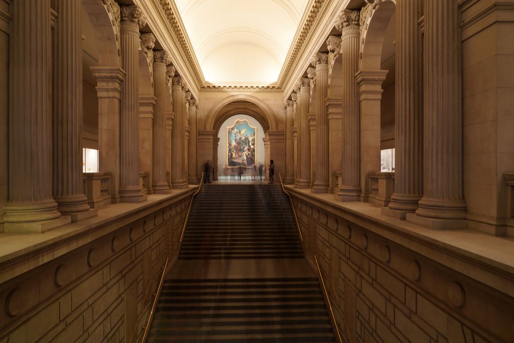 The grand staircase of the Metropolitan Museum of Art rising from the Great Hall under a coffered vault, New York