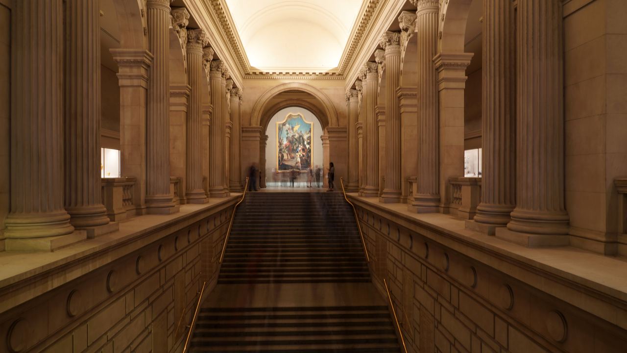 The grand staircase of the Metropolitan Museum of Art rising from the Great Hall under a coffered vault, New York