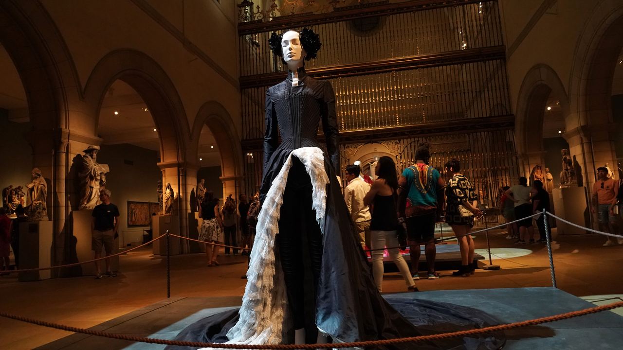 The Medieval Sculpture Hall of the Metropolitan Museum of Art with the Spanish choir screen, arches and visitors, New York