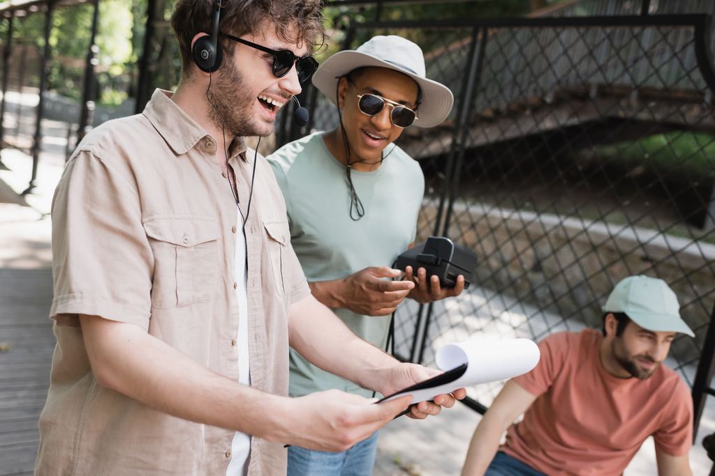 A tour guide wearing a headset checks the route on a clipboard beside a small group of tourists
